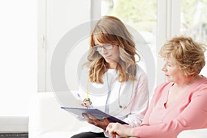 Female doctor with senior patient