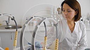 Female doctor setting up medical machine.