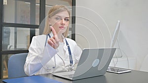 Female Doctor Shaking Head in Denial at Work