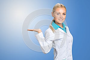 Female doctor showing blank area for sign or copyspace