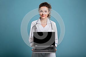 Female doctor showing blank laptop screen