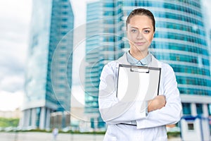 Female doctor showing clipboard