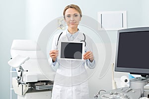 Female doctor showing digital tablet with
