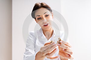 Female Doctor Showing Hearing Aid