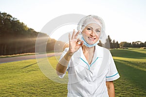 Female doctor showing ok sign.