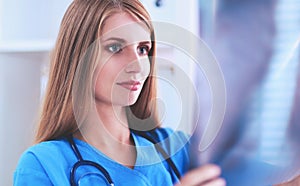 Female doctor showing x-ray at hospital