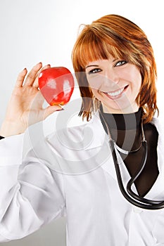 female doctor showing red apple