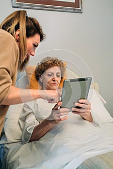 Female doctor showing results of a medical test on the tablet