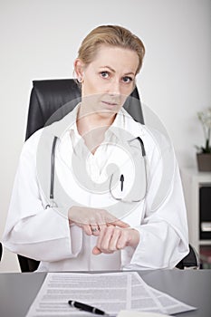 Female Doctor Showing What is the Time Gesture