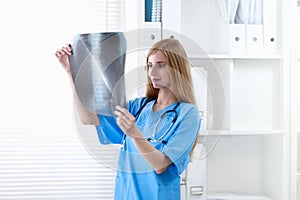 Female doctor showing x-ray at hospital