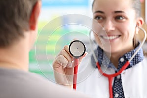 Female doctor shows patient stethoscope membrane