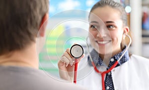 Female doctor shows patient stethoscope membrane
