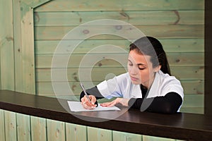 The female doctor sits at a table having closed eyes for fatigue