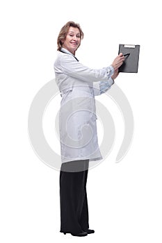 Female doctor smiling and showing a clipboard with an empty document