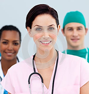 Female Doctor standing in Front of her team