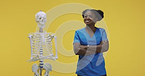 Female doctor standing by a skeleton