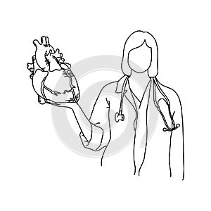 Female doctor with stethoscope on her neck holding a human heart