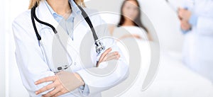 Female doctor with stethoscope standing upright with crossed arms, unknown physician at work. Medicine concept
