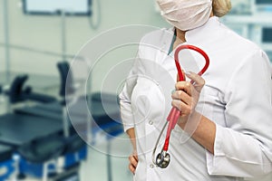 A female doctor with a stethoscope is in the surgical ward