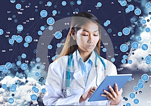 Female doctor with stethoscope using digital tablet