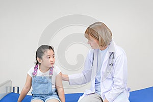 Female doctor support cheer little cute girl examine consult in hospital, Kid on consultation at the pediatrician. Healthcare and
