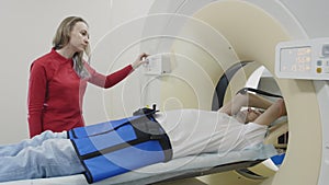Female doctor switch on CT scan for patient computed diagnostics