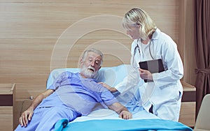 Female doctor taking care aging male patient