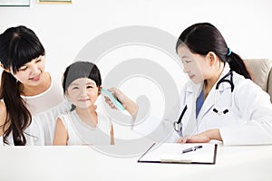 Female doctor Taking temperature using in ear thermometer