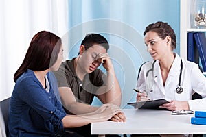 Female doctor talking with her patients photo