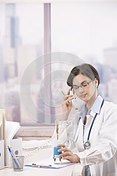 Female doctor talking on phone