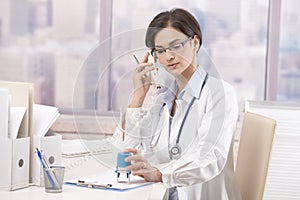 Female doctor talking on phone