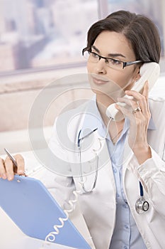 Female doctor talking on phone