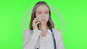 Female Doctor Talking on Phone on Green Background