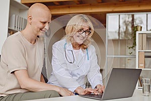 Female Doctor Talking to Patient in Clinic