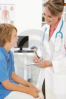 Female doctor talking to young boy