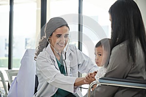 Female doctor teases boy before examination.