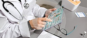 Female doctor touching transparent tablet with medical digital diagnostic on screen