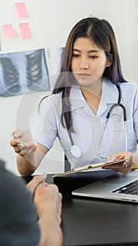 A female doctor treating a patient makes an appointment to hear the results after a physical examination. along with explaining me