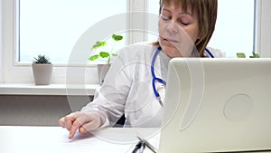 Female Doctor Typing on Computer Keyboard in Office