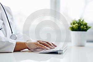 Female doctor typing on keyboard