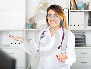 Female doctor in uniform inviting to doctor's office