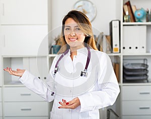 Female doctor in uniform inviting to doctor's office