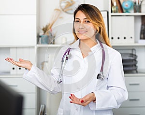 Female doctor in uniform inviting to doctor's office