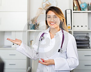 Female doctor in uniform inviting to doctor's office