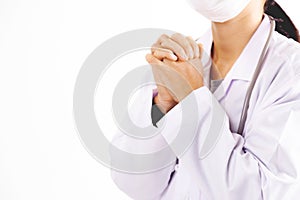 The female doctor in uniform is praying.