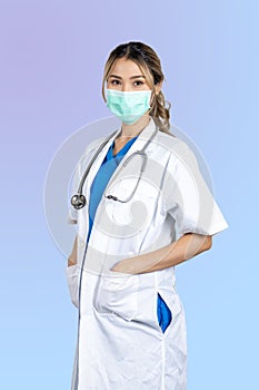 Female doctor in uniform standing alone and put her hands in pocket