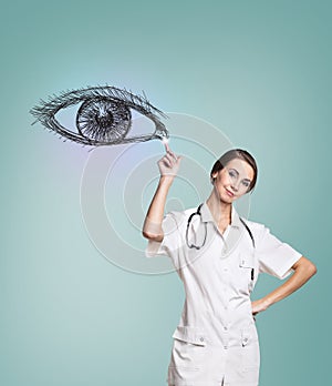 Female doctor in uniform touch painted human eye