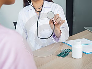 Female doctor use stethoscope examines a patient in a hospital. Clinical and healthcare concept. Medicine treatment for adult.