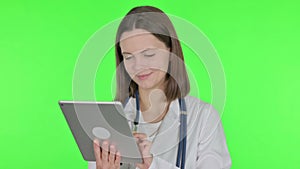 Female Doctor using Digital Tablet on Green Background