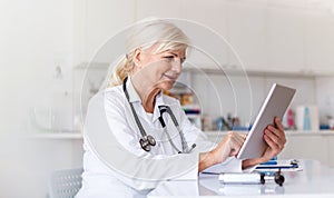 Female doctor using digital tablet in her office